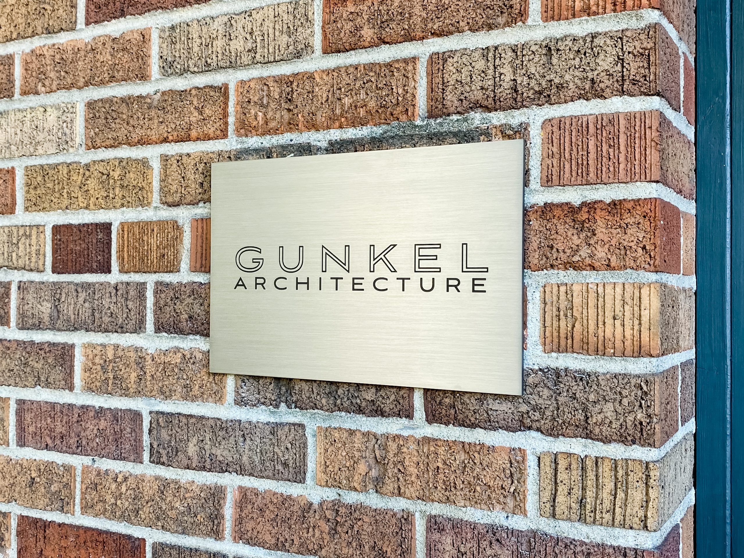 Engraved and paint filled metal sign for Gunkel Architecture, a studio focused on sustainable, community-focused architecture.