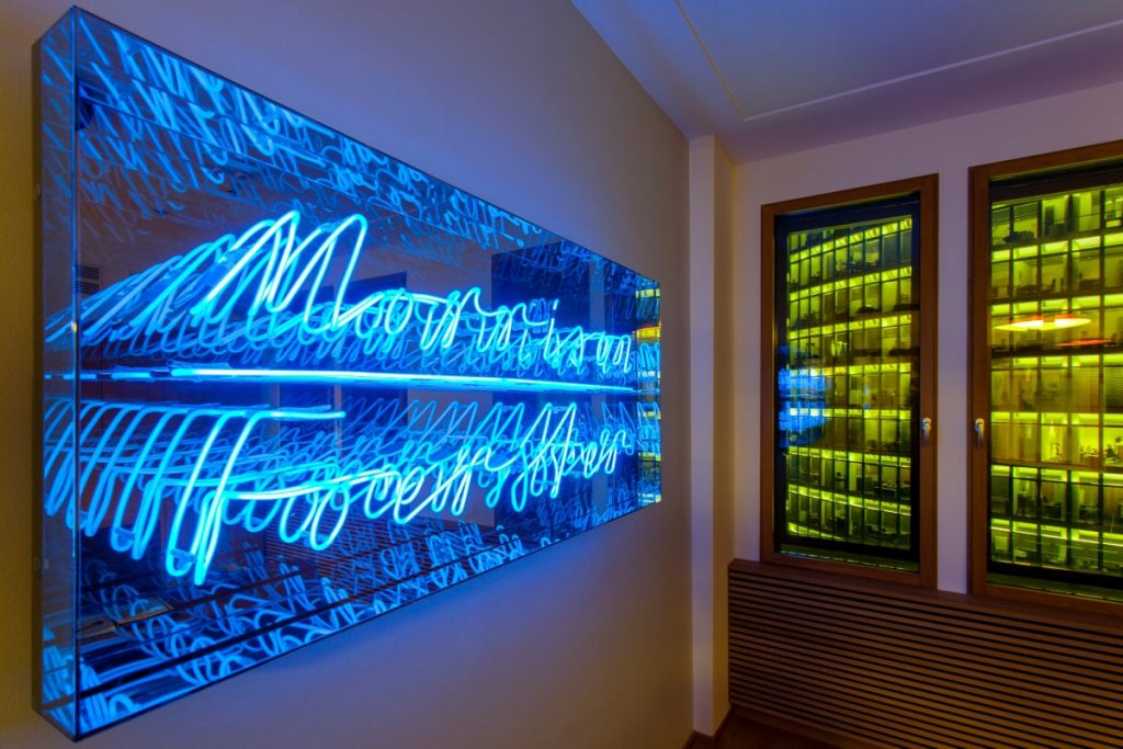 Blue neon on mirrored backdrop for the office of Morrison Forester in Berlin, Germany. (Photo: Asaf Oren)