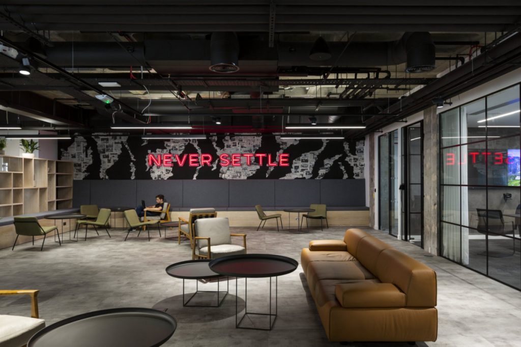 Red neon in channel letters on black breakout space office wall. (Photo: Tom Fallon)