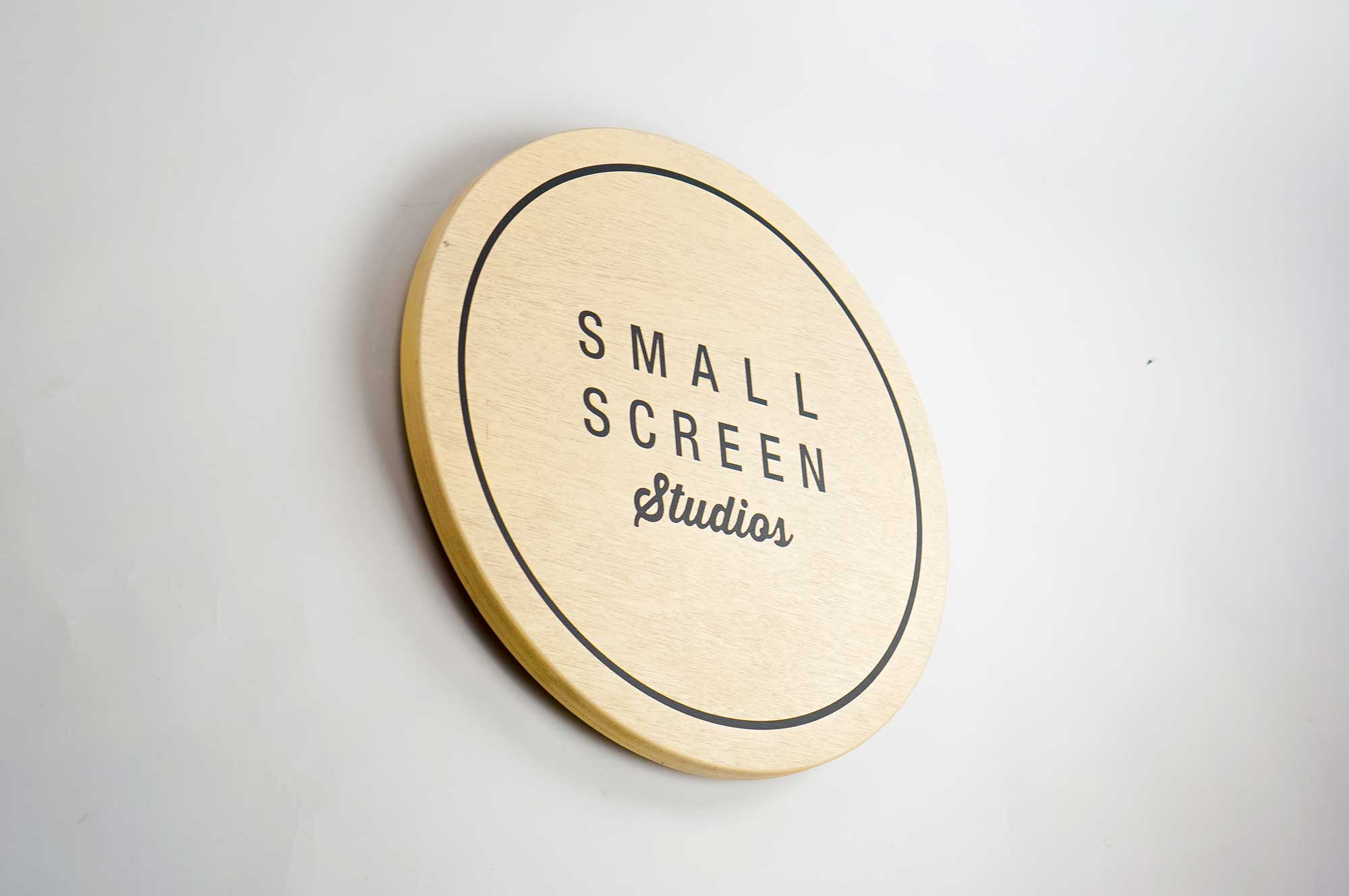 small-screen-studios Wood hanging blade sign with black artwork for the storefront of Small Screen Studios, a shop in Cleveland, OH.