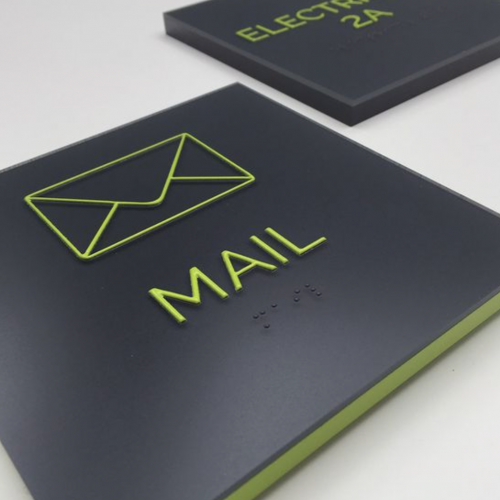 black-room-signs-neon-green-edge Matte black ADA room sign with neon green text and matching green edge, designed by Yount Design for Nine East 33rd, a luxury apartment community.