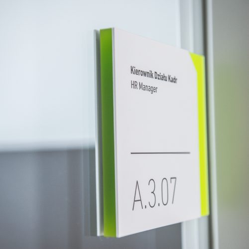 Modern white room sign with neon reveal, designed by Blank Studio for The Silesian Musuem in Katowice.