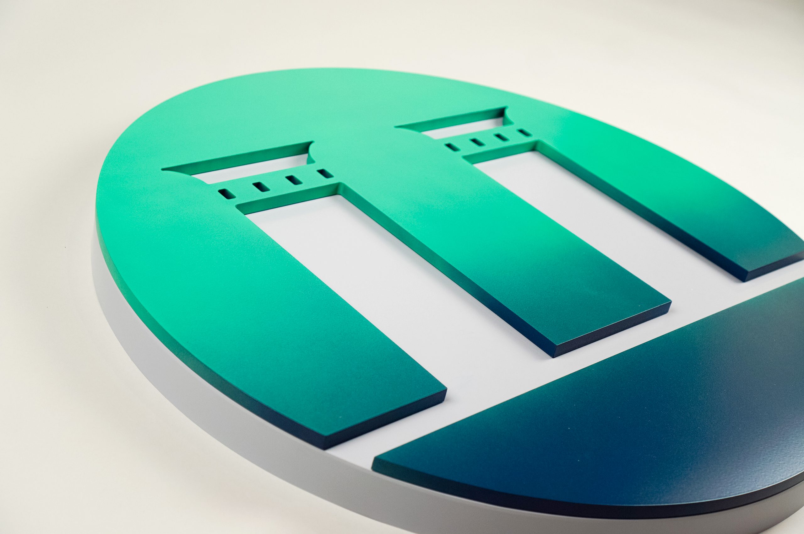 Gradient/ombre blue and green painted round logomark for the front desk of Pillar Biosciences, a clinical cancer diagnostics company based in Natick, MA.