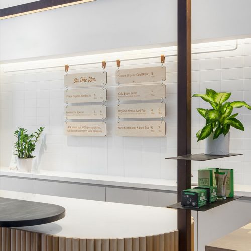leather-wood-hanging-menu-placards Etched wood menu placards hanging on rail at Village Juicery in Toronto, Canada. Design by Mason Studio.