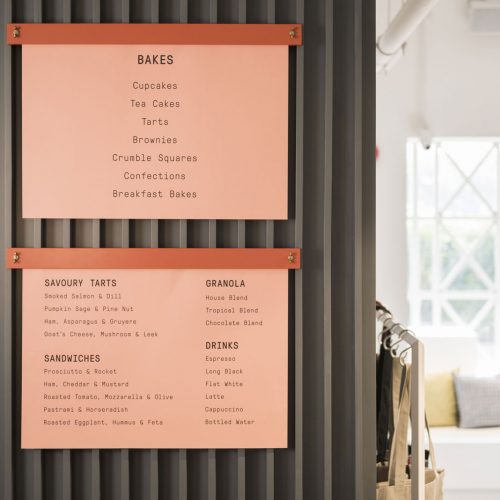 Printed menu hanging from poster frame in Foreign Policy in Singapore. Typeface by Grilli Type.