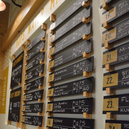 Individual chalkboard menu items in custom wood display at a brewery. Created by D Fab Design.