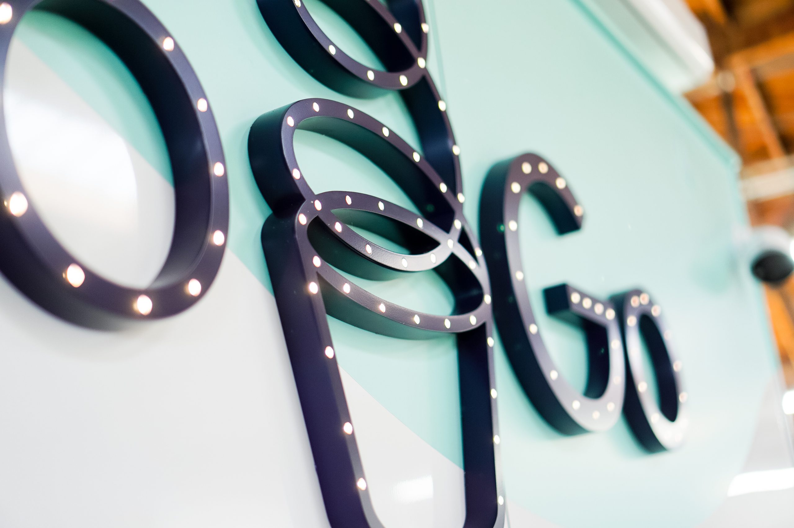 Illuminated, marquee-style sign on food truck for FroGo, a customizable, self-serve, dairy-free, frozen yogurt truck.
