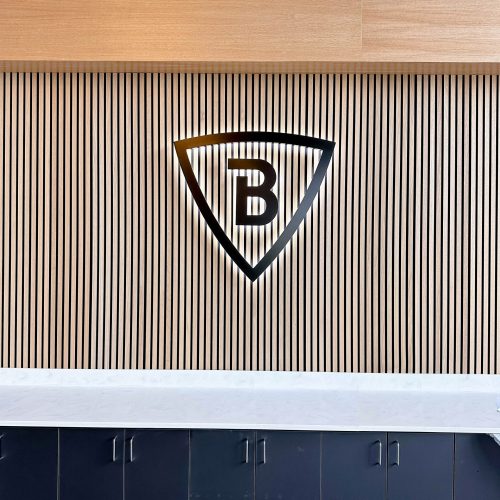 Illuminated black logo with white backlight on slat wood wall for the lobby of Brave Church, a church located in the Dublin and San Ramon, CA.