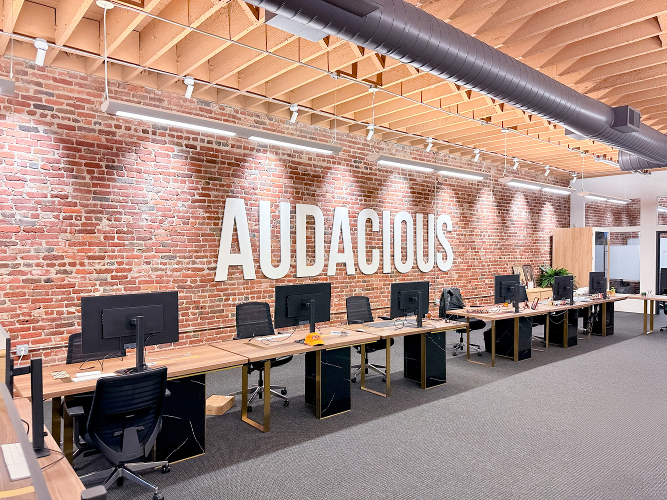 audacious-white-sign-brick-wall-3