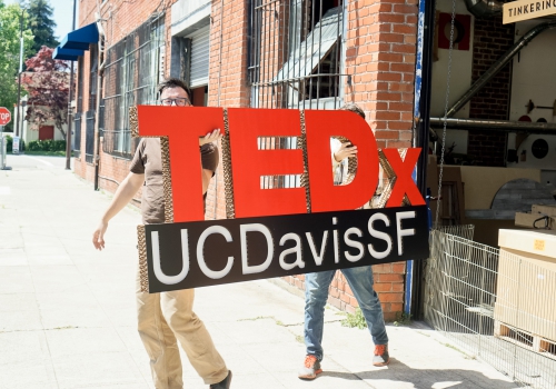carrying large TEDx stage sign carrying large TEDx stage sign