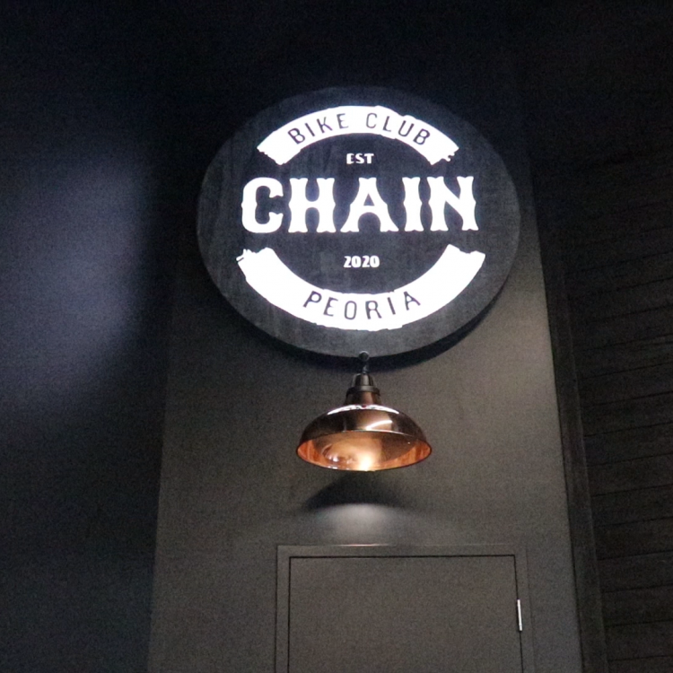 Faux rusty metal illuminated sign for Chain, a cycling studio in Styles Studios Fitness, a fitness club in Peoria, IL.