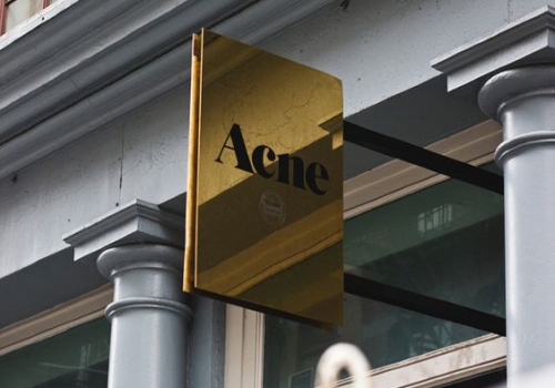 high gloss polished brass blade sign on building high gloss polished brass blade sign on building