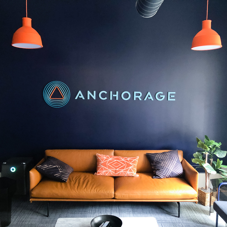 Painted, multi-color acrylic sign on a dark, navy blue wall for the lobby of Anchorage, a San Francisco-based company focused on creating custody solutions for the cryptocurrency ecosystem.