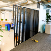 Custom slat wood and metal divider wall for the San Francisco office of Asana, a web and mobile application designed to help teams organize, track, and manage their work.