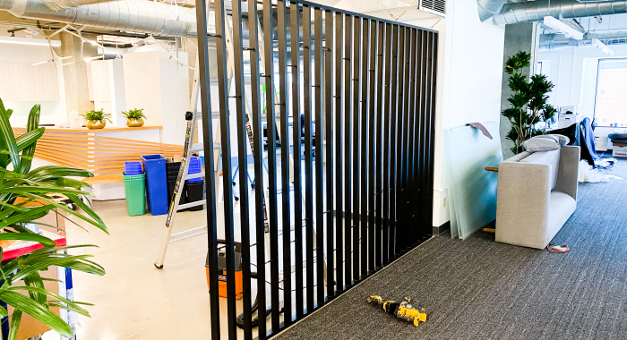 Custom slat wood and metal divider wall for the San Francisco office of Asana, a web and mobile application designed to help teams organize, track, and manage their work.