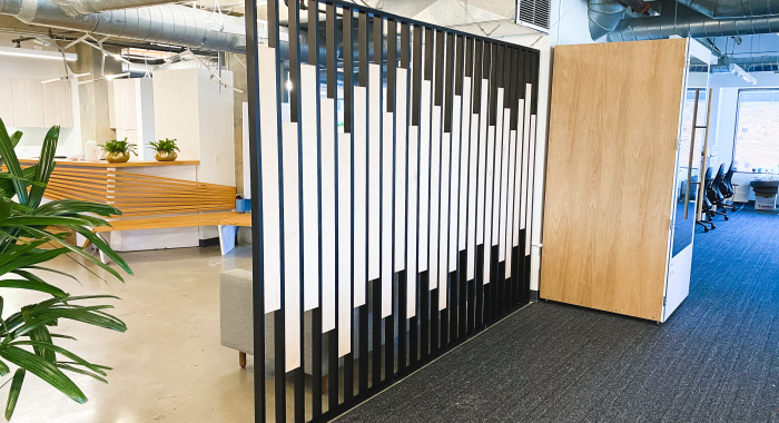 Custom slat wood and metal divider wall for the San Francisco office of Asana, a web and mobile application designed to help teams organize, track, and manage their work.
