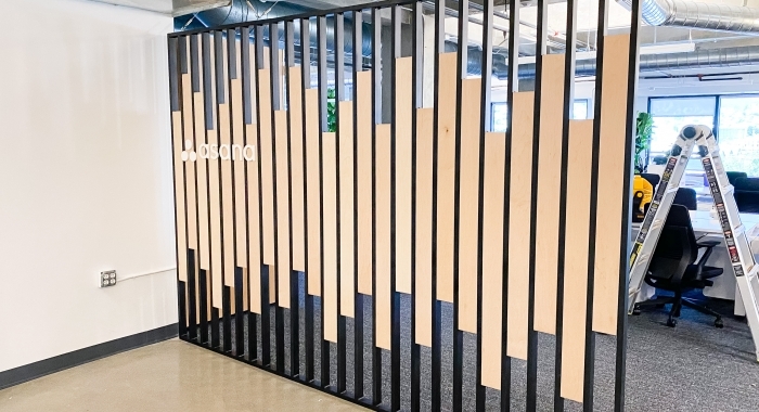 Custom slat wood and metal divider wall for the San Francisco office of Asana, a web and mobile application designed to help teams organize, track, and manage their work.