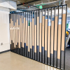 Custom slat wood and metal divider wall for the San Francisco office of Asana, a web and mobile application designed to help teams organize, track, and manage their work.