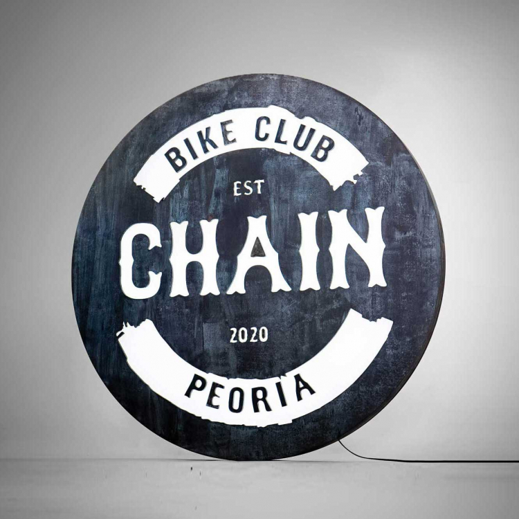 Faux rusty metal illuminated sign for Chain, a cycling studio in Styles Studios Fitness, a fitness club in Peoria, IL.