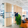 Optical-illusion, multi panel wood sign / privacy screen at the San Francisco office of Compass, a modern real estate platform.