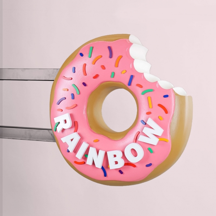 3D, pink-frosted, sculptural, sprinkle donut blade sign for Rainbow Donuts in Berkeley, CA