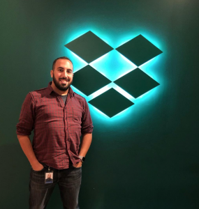 Man standing in front of color-on-color illuminated dropbox sign, made by tinkering monkey