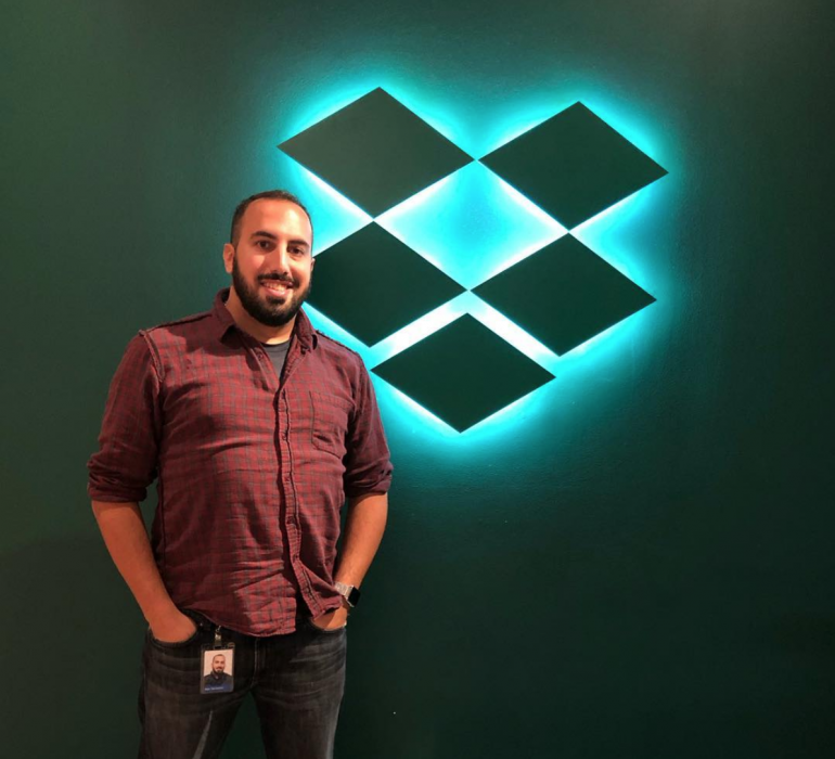 Man standing in front of illuminated dropbox sign, made by tinkering monkey