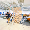 Slat wood divider wall installation for Flexport, a freight forwarding and customs brokerage company based in San Francisco, California.