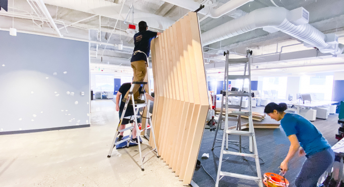 Slat wood divider wall installation for Flexport, a freight forwarding and customs brokerage company based in San Francisco, California.