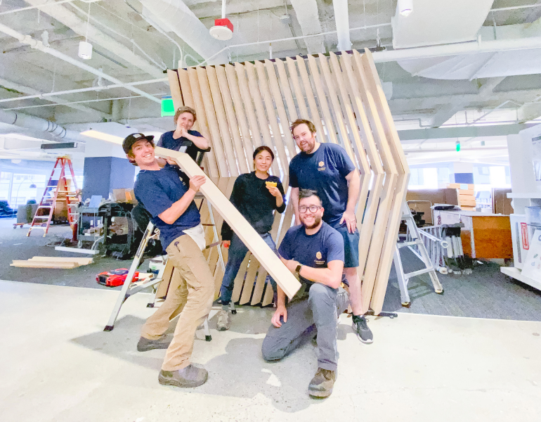 Slat wood divider wall installation for Flexport, a freight forwarding and customs brokerage company based in San Francisco, California.