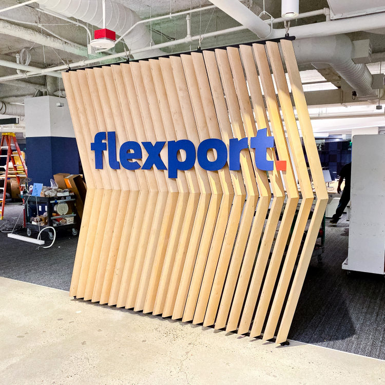 Slat wood divider wall installation for Flexport, a freight forwarding and customs brokerage company based in San Francisco, California.