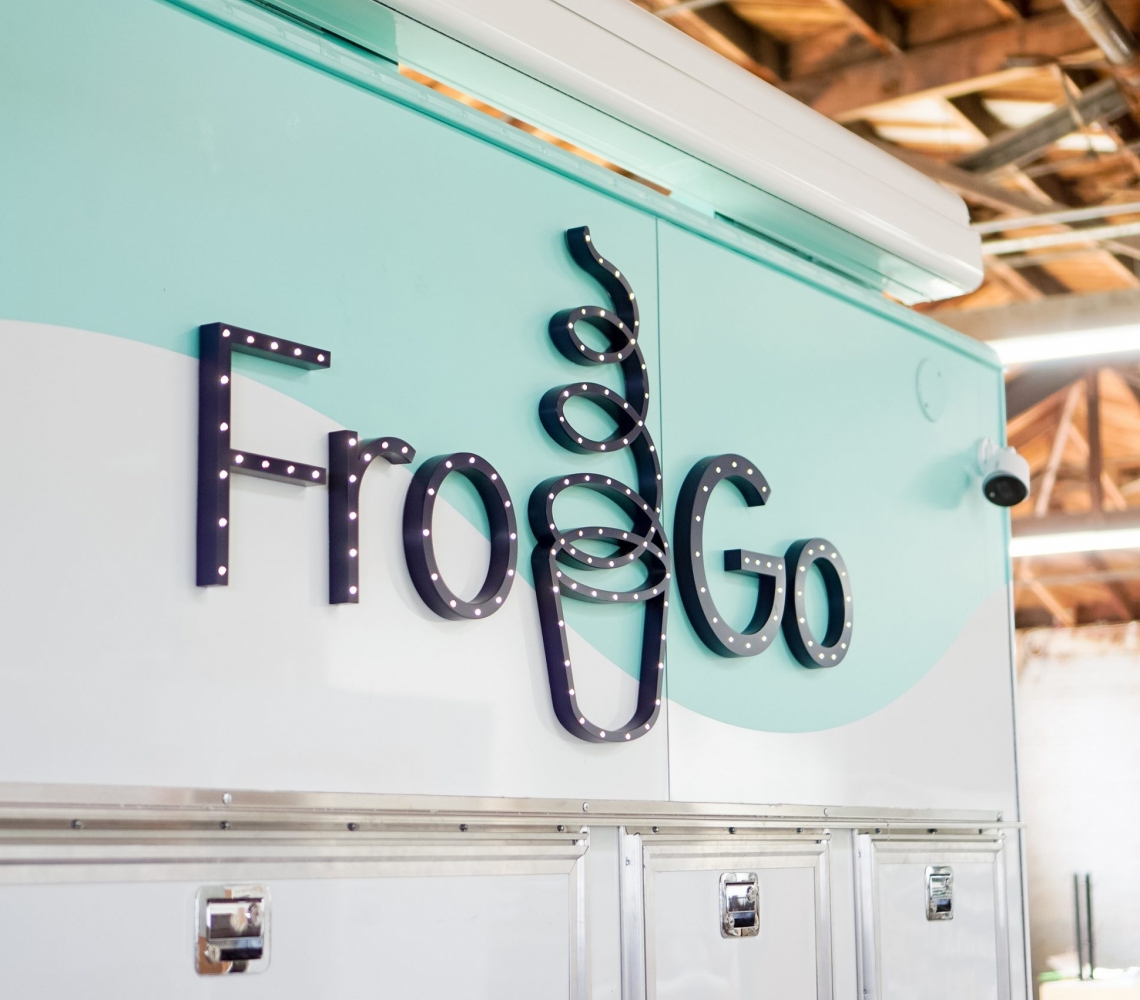 Illuminated, marquee-style sign on food truck for FroGo, a customizable, self-serve, dairy-free, frozen yogurt truck.