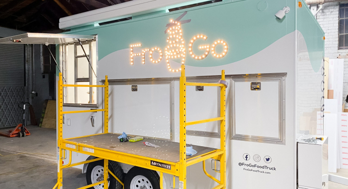 Illuminated, marquee-style sign on food truck for FroGo, a customizable, self-serve, dairy-free, frozen yogurt truck.