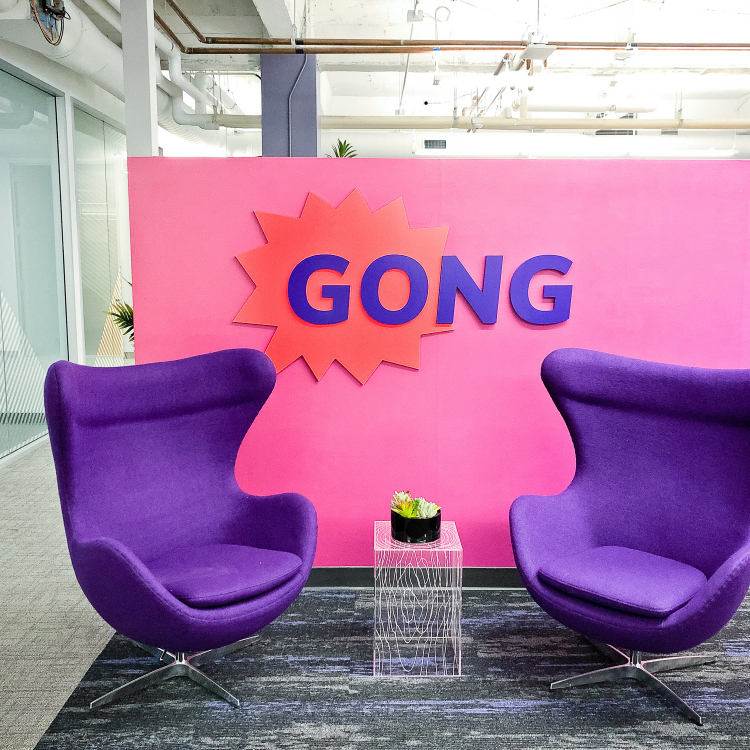 Red and purple painted sign for the San Francisco lobby of Gong, makers of a conversation intelligence platform for sales.