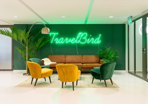 Green neon sign on green painted wall for the lobby of Travelbird, in Amsterdam, Netherlands. (Photo: June Studio Amsterdam)