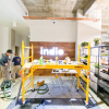 Full wall installation with dark wood and an illuminated, built-in logo for the San Francisco lobby of Indio, a company that simplifies the insurance application process for brokers and their clients.