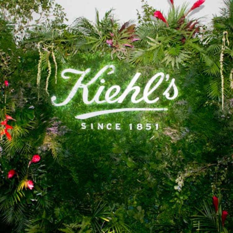 Illuminated sign on living wall at Kiehl's event