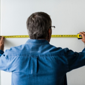 man-measuring-wall man measuring wall