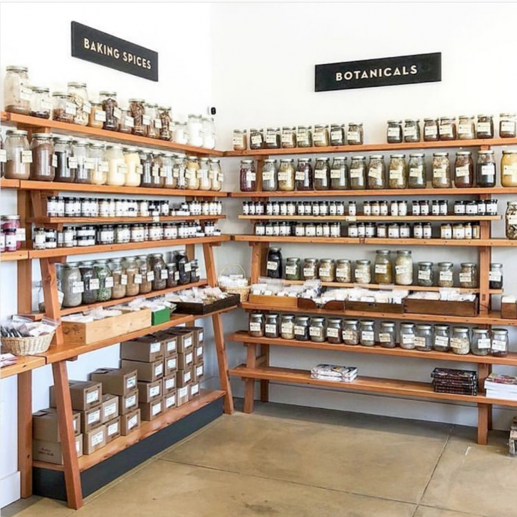 Black and wood section signs at Oaktown Spice, a spice shop in Oakland, CA.