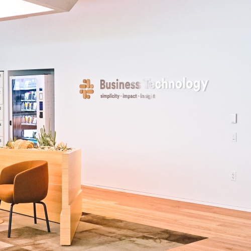 Wood and metal sign for the Business Technology department at Slack, an American cloud-based set of team collaboration tools and services.