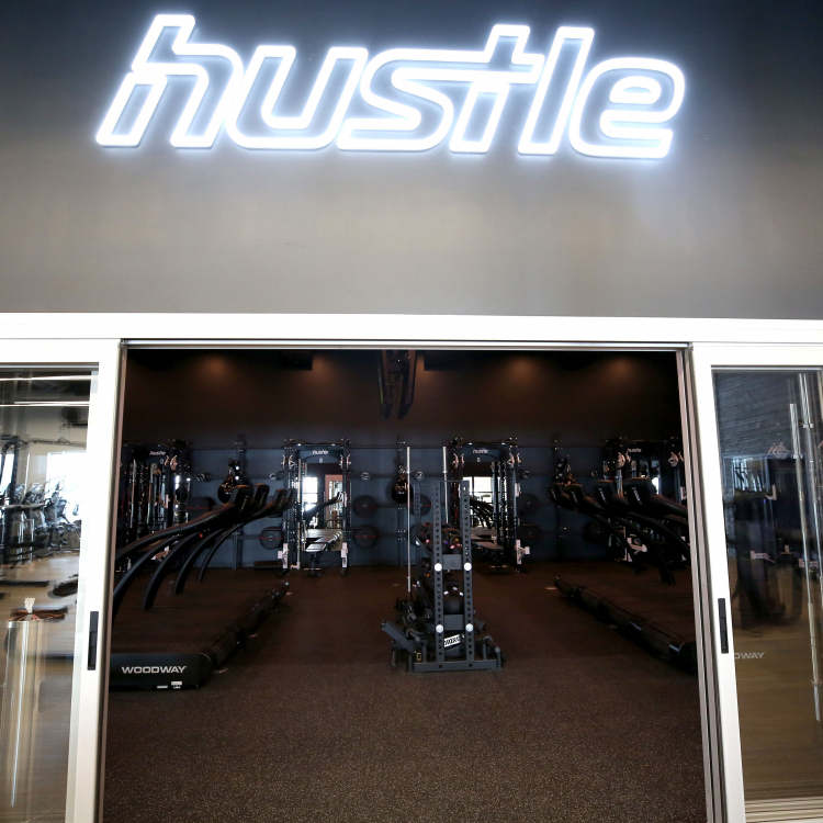 Neon style sign for Hustle, a strength and cardio studio inside Styles Studios, a fitness club in Peoria, IL.