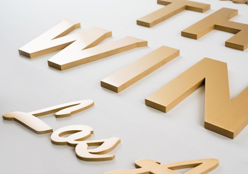 Retro, brass colored sign made from brushed, solid bronze for The Wing, a co-working space in Los Angeles. Retro, brass colored sign made from brushed, solid bronze for The Wing, a co-working space in Los Angeles.