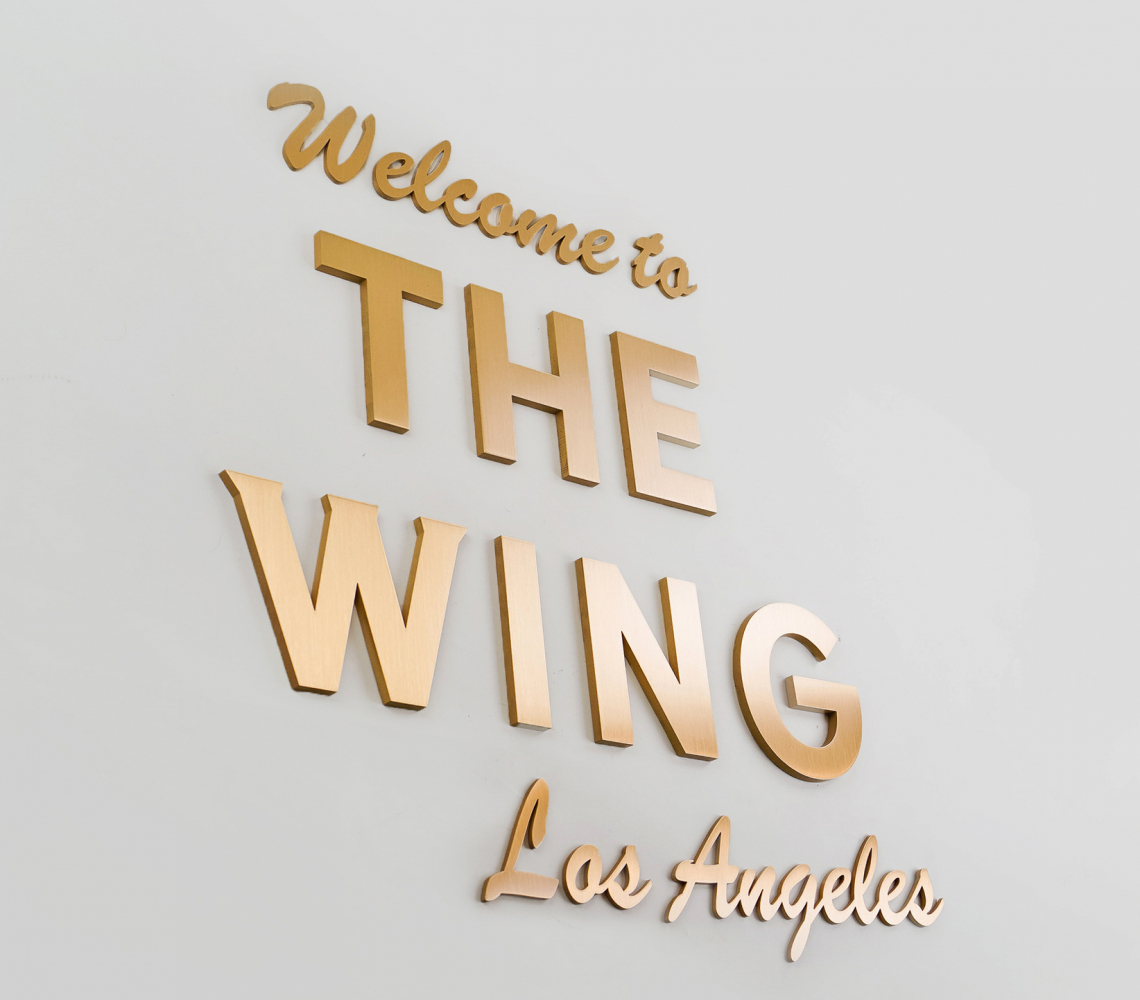 Retro, brass colored sign made from brushed, solid bronze for The Wing, a co-working space in Los Angeles.