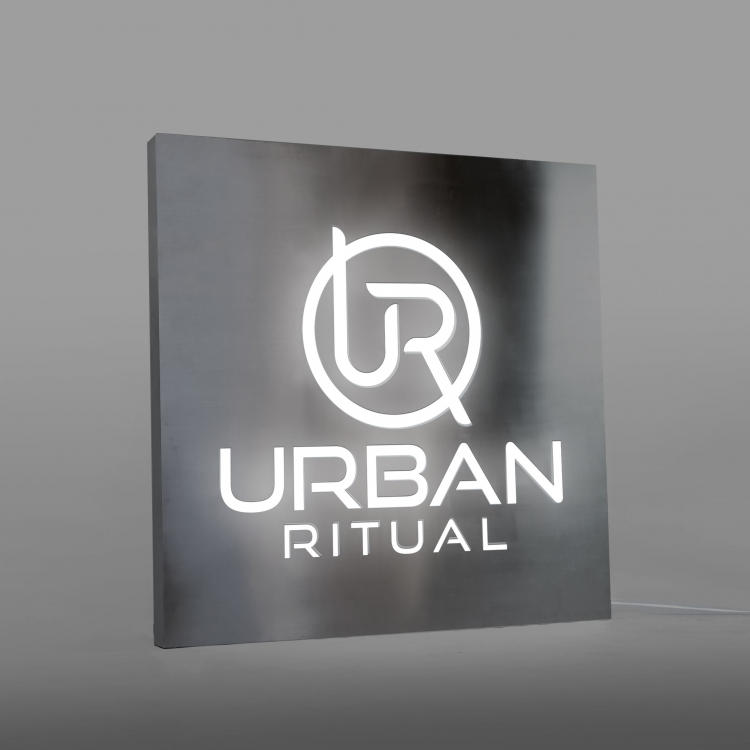 Brushed steel, interior-lit, large square wall sign for Urban Ritual, a fitness studio located in Styles Studios, a boutique fitness studio in Peoria, IL.